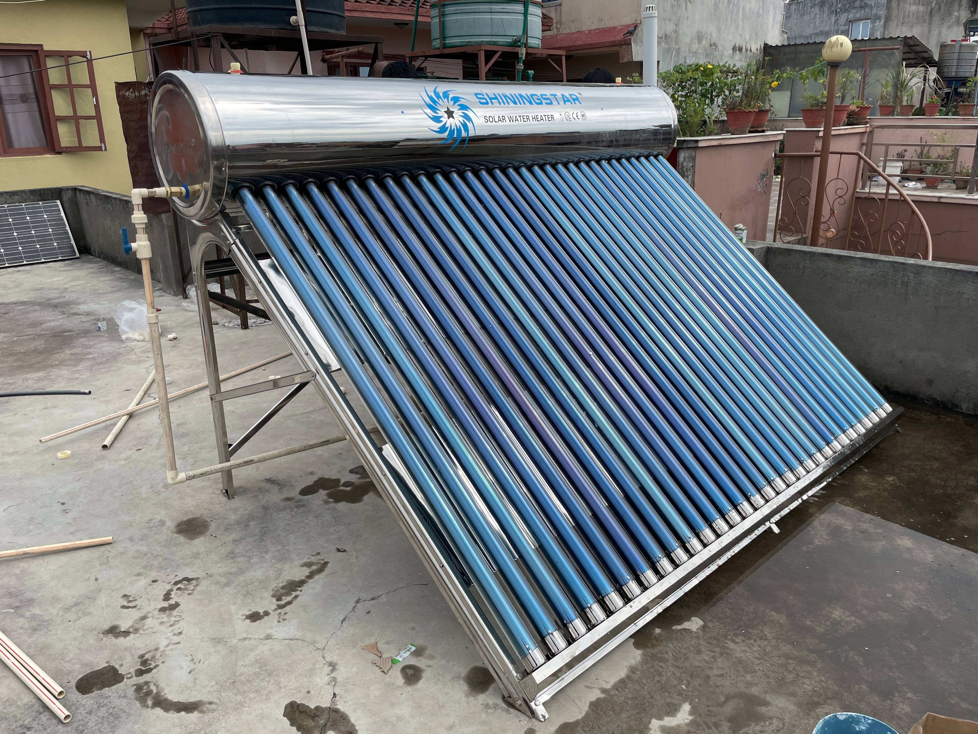 A sleek solar water heater on a rooftop, with flat-plate collectors angled towards the sun.