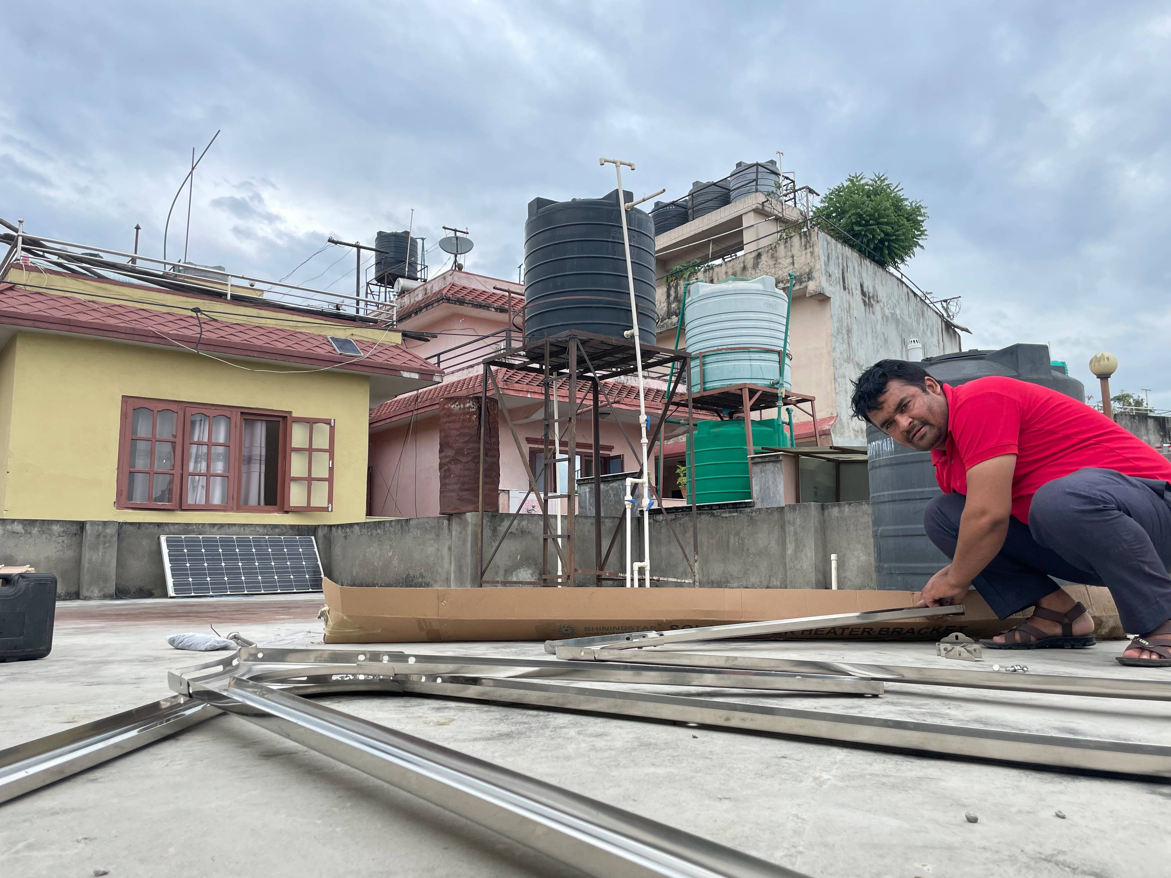 A sleek solar water heater on a rooftop, with flat-plate collectors angled towards the sun.